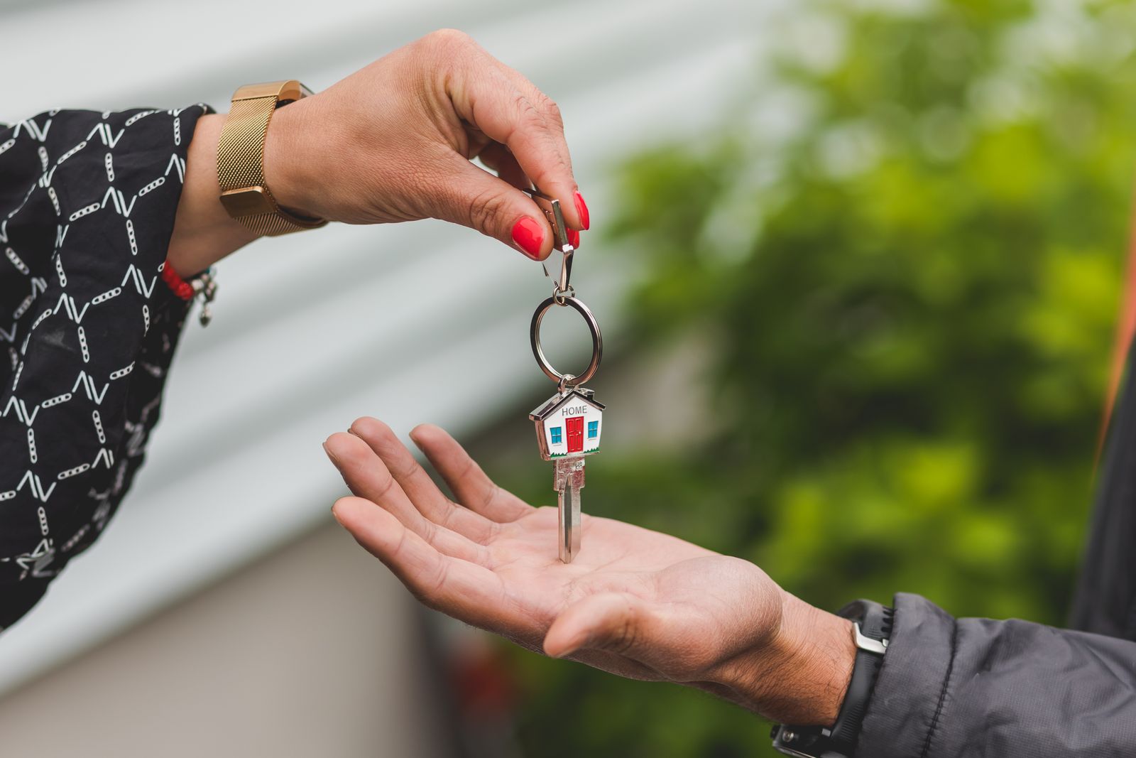 Hand handing over a house key