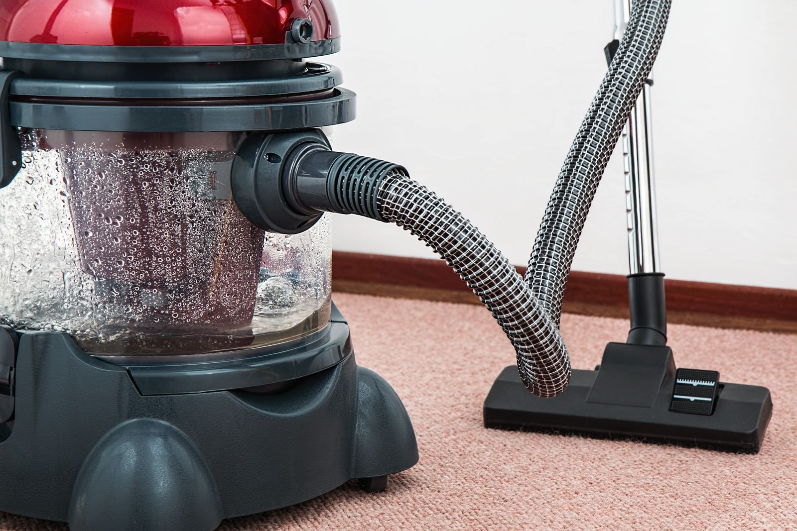 Modern vacuum cleaner on a carpet floor