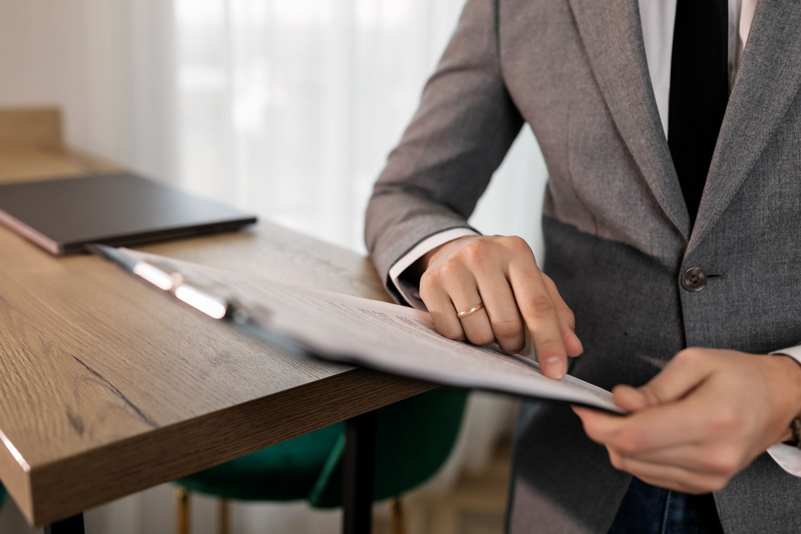 Professional reviewing documents on a clipboard