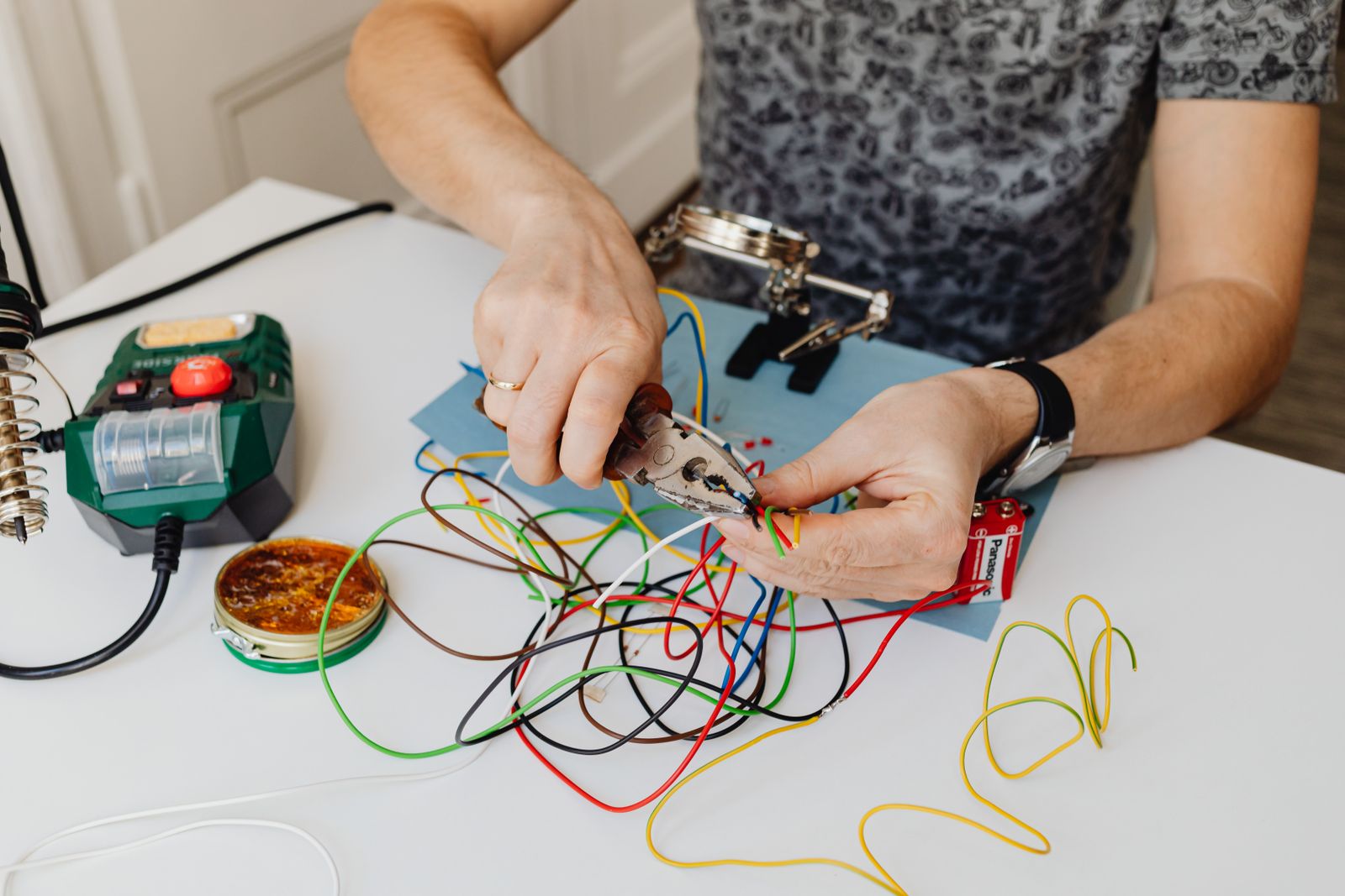 Technician organizing colorful wires during electrical work