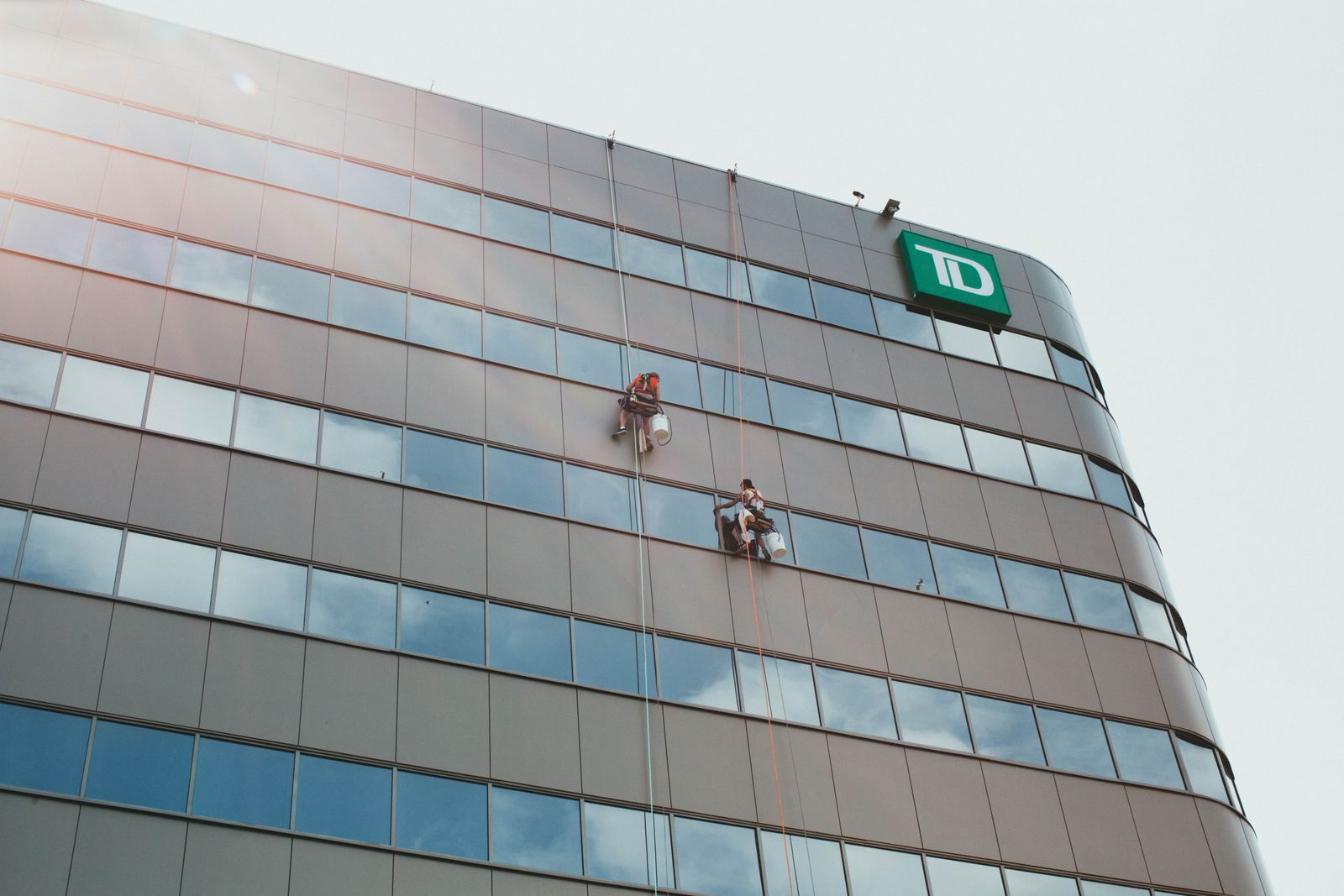 Workers cleaning the glass facade of a skyscraper