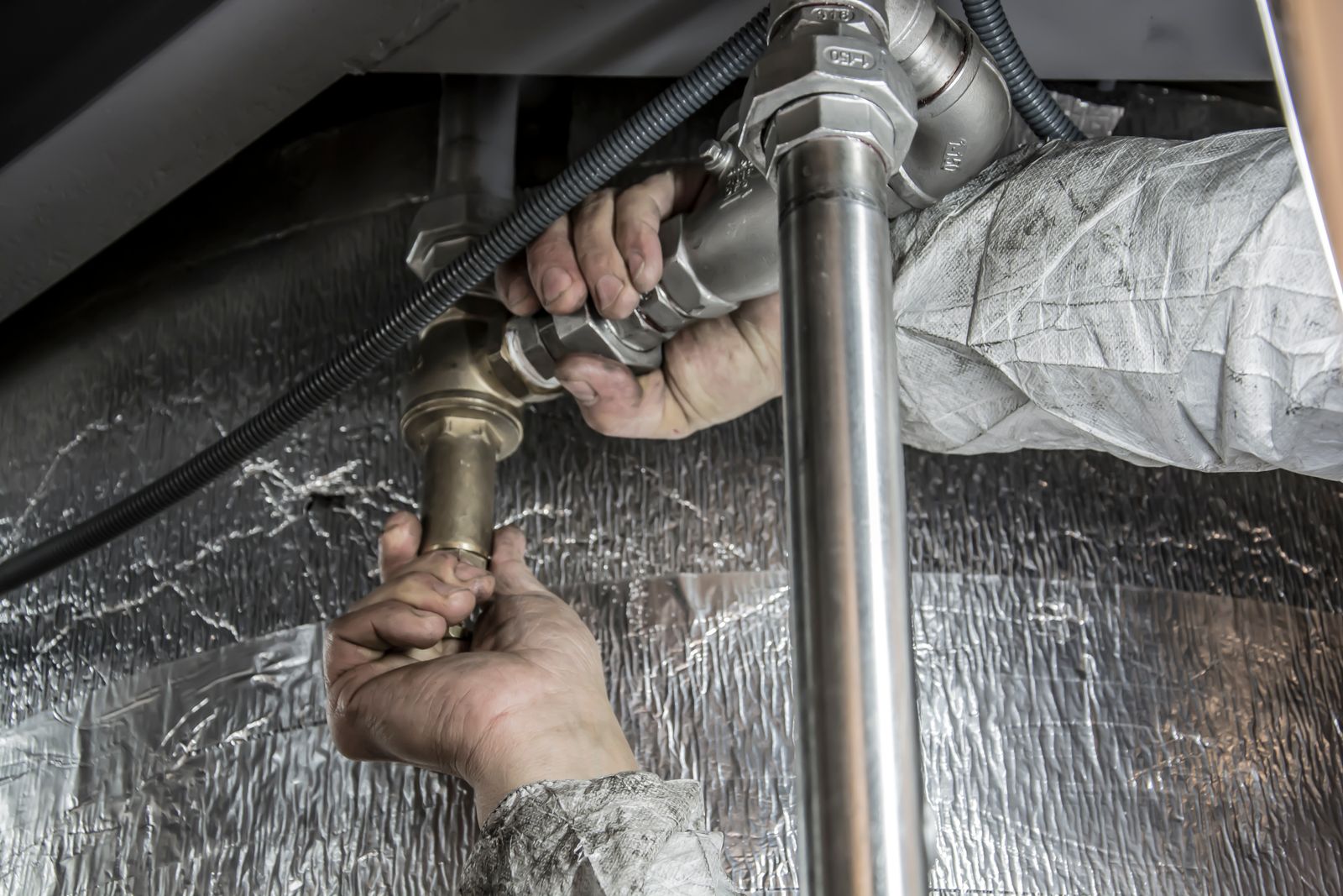 Plumber installing steel pipes