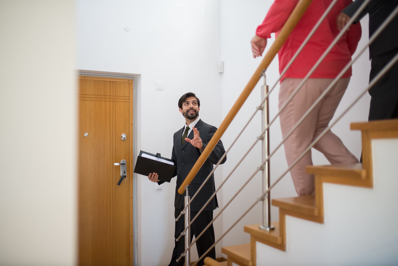 Real estate agent showing a property to clients