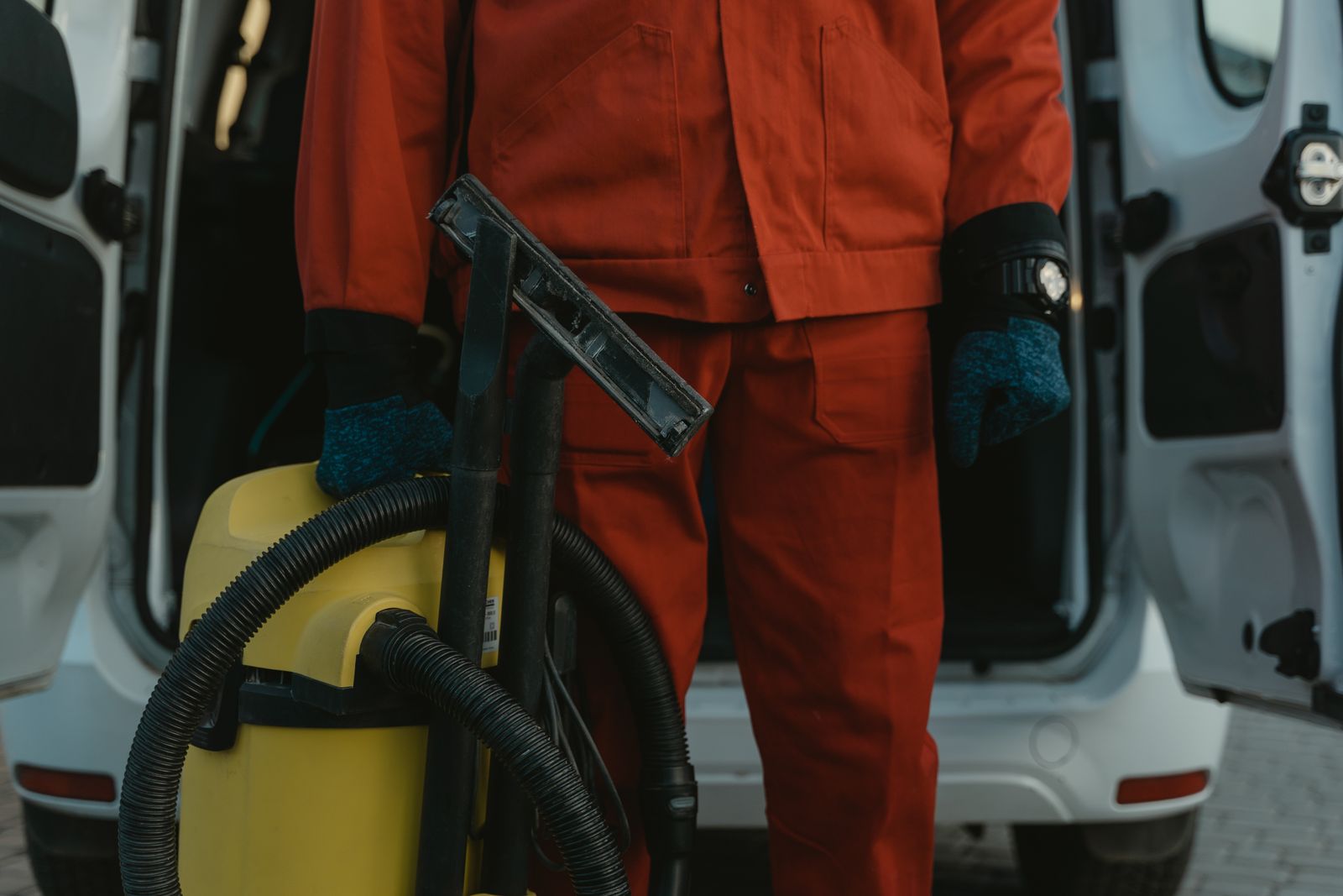 Professional cleaner holding a vacuum