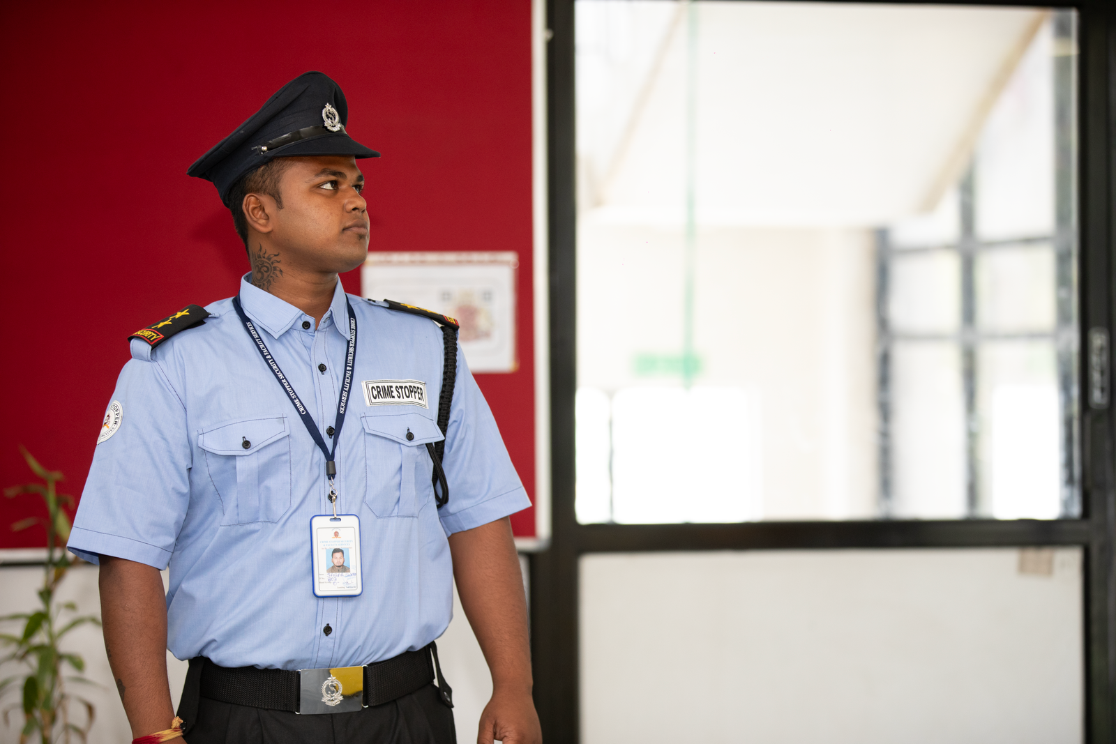 Security guard standing alert at a building entrance